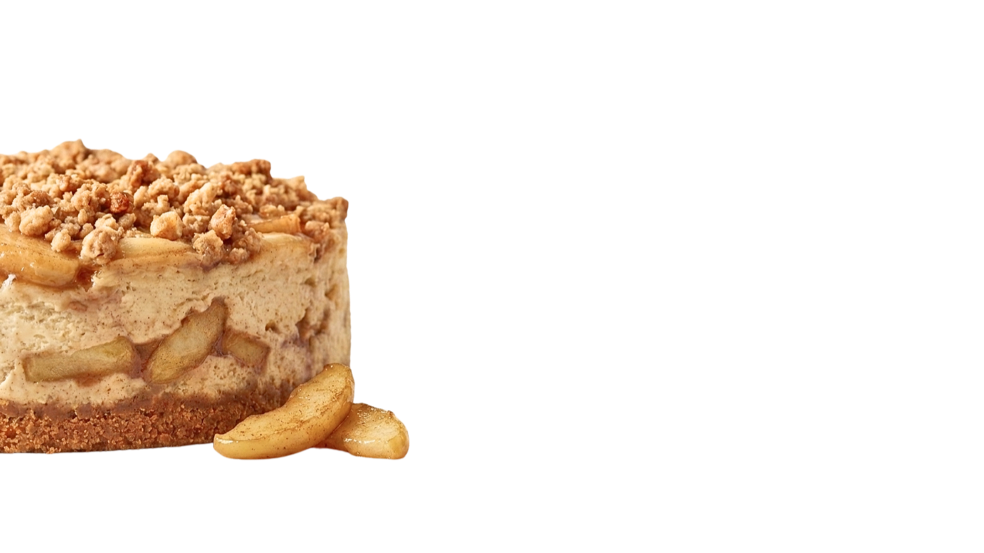 Caramel-apple cheesecake topped with fresh apple slices and toffee crumble